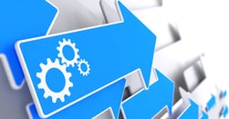 Cogwheel Gear Mechanism Icon on Blue Arrow on a Grey Background.-2