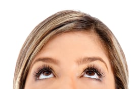 Eyes of a woman looking up - isolated over a white background