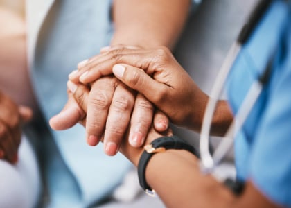 caring medical provider holding hands