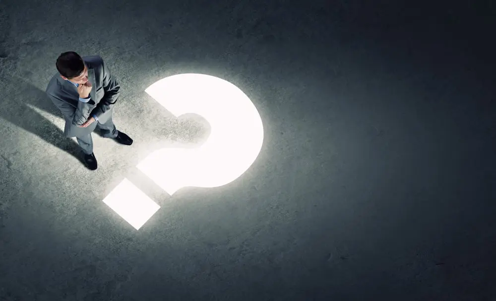 Top view of businessman looking at question mark on floor