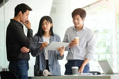 3 people in meeting drinking coffee