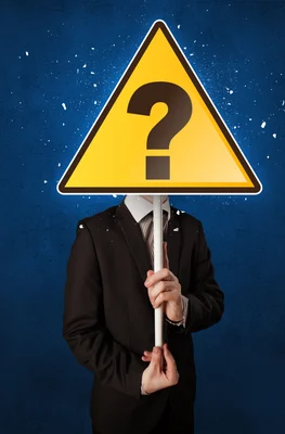 Smart businessman holding yellow sign with question mark