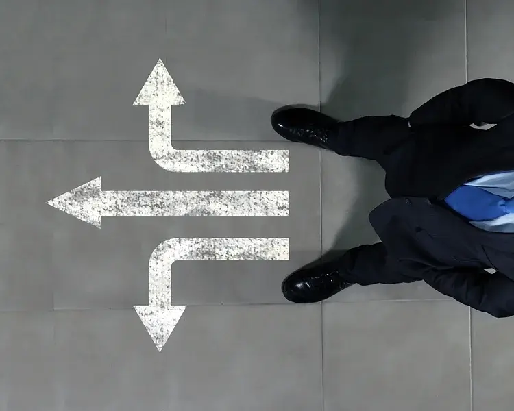 Business man with arrows at feet