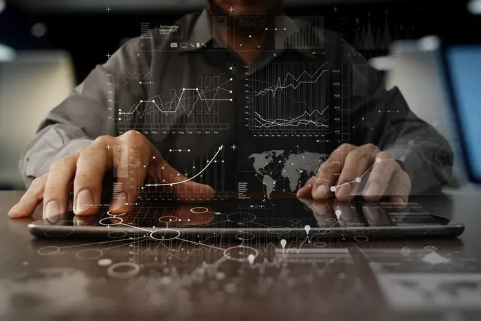 businessman hand working on laptop computer with digital layer business strategy and social media diagram on wooden desk