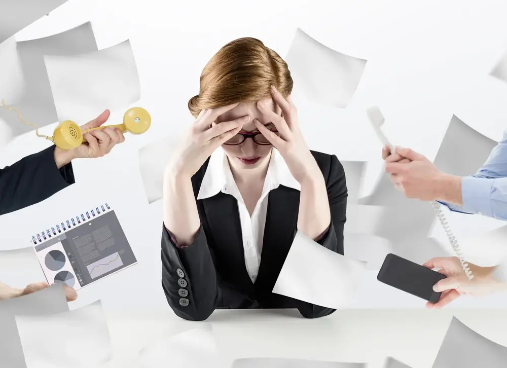 hand holding phone against sheets of paper flying