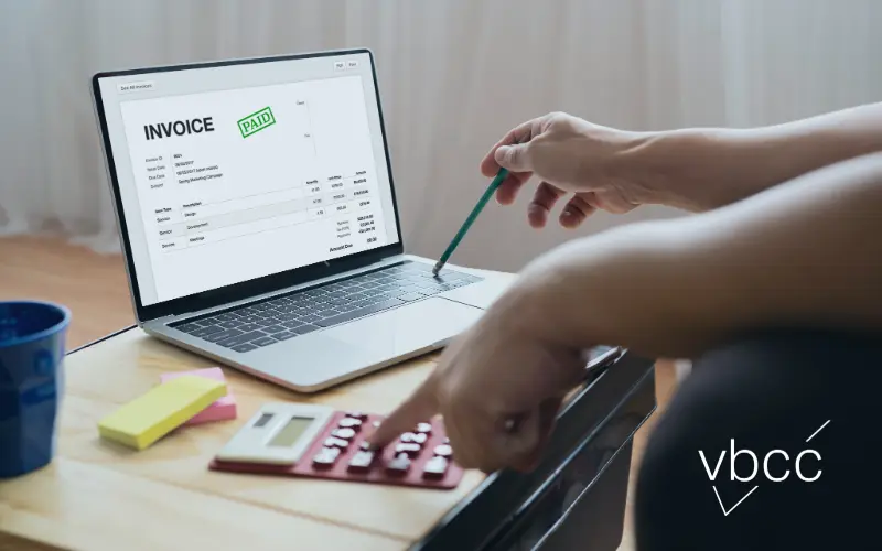 Woman on laptop looking at invoice