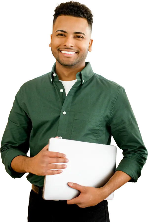 man in green shirt holding laptop